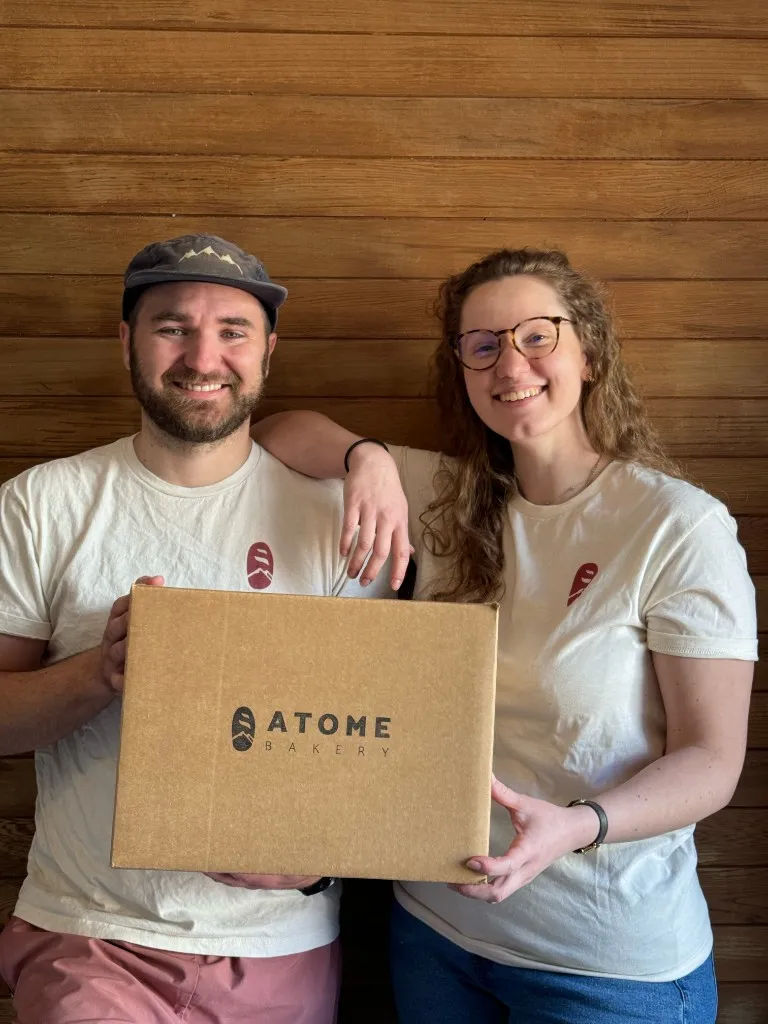 F2C's founders holding an Atome Bakery shipping box
